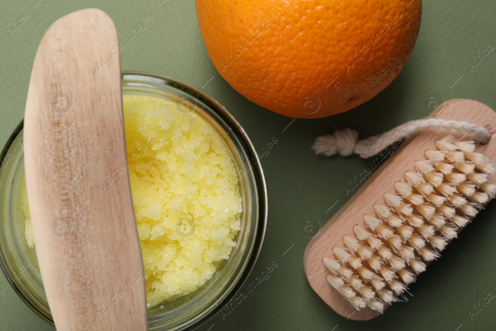 Photo of Flat lay composition with natural body scrub on olive background. Anti cellulite treatment