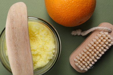 Photo of Flat lay composition with natural body scrub on olive background. Anti cellulite treatment