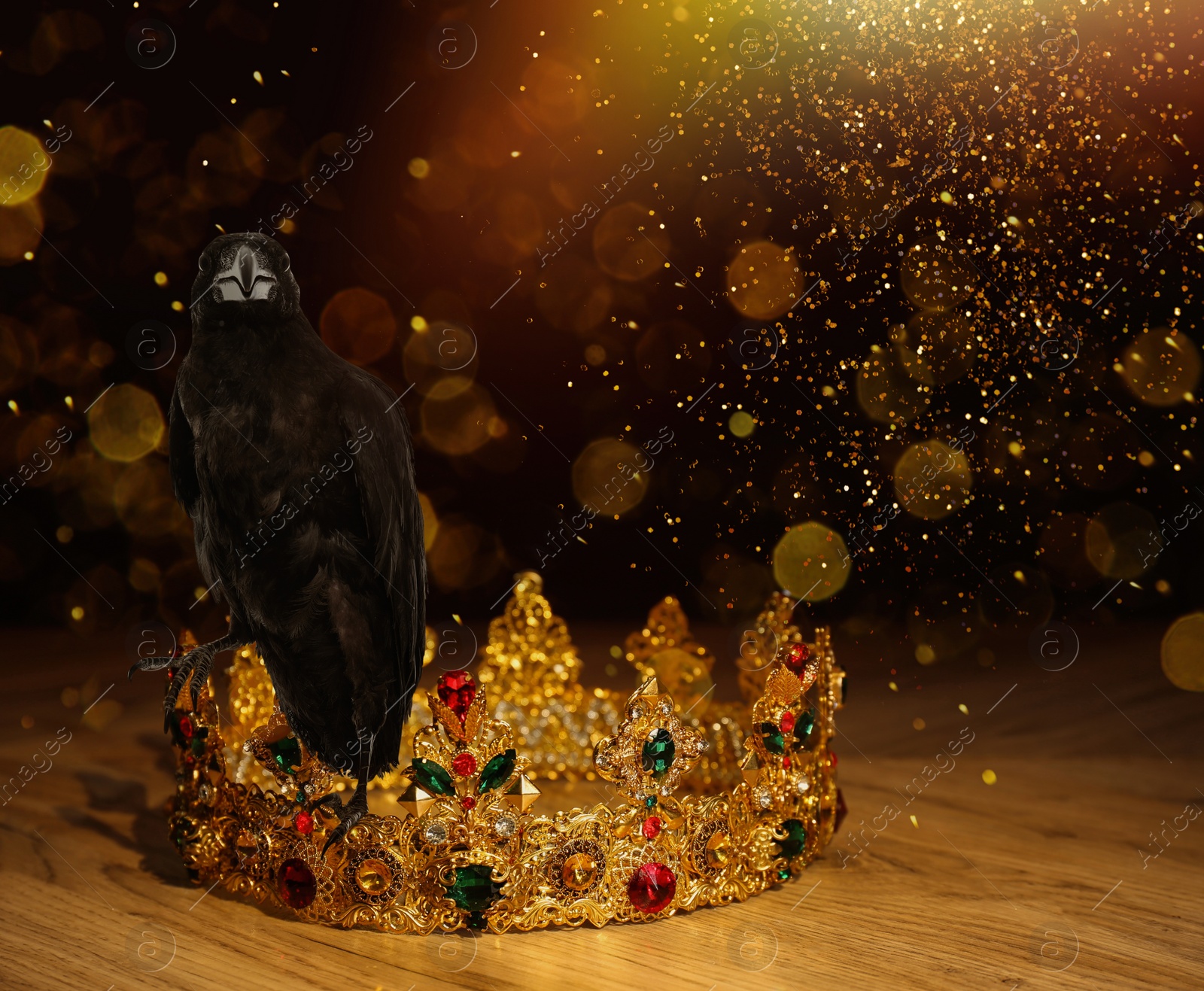 Image of Fantasy world. Black crow lit by magic light sitting on golden crown, bokeh effect
