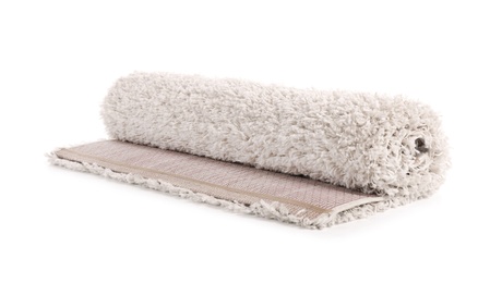 Photo of Rolled fuzzy carpet on white background. Interior element