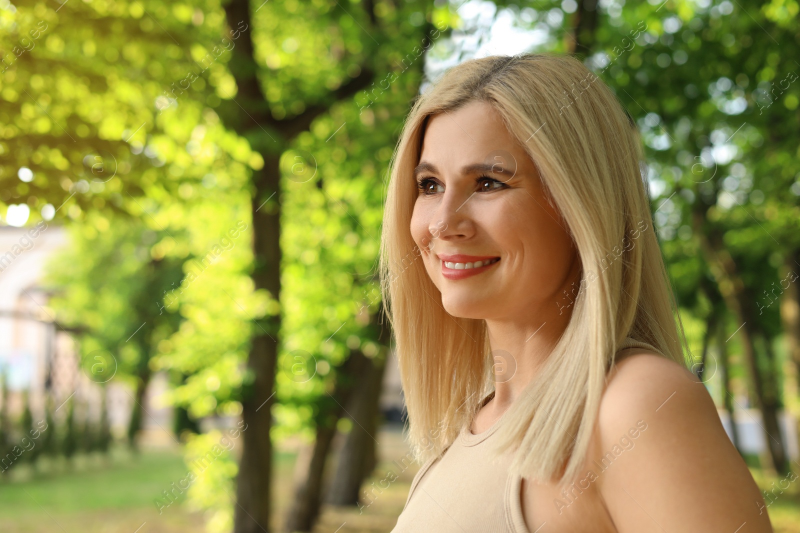 Photo of Portrait of beautiful woman outdoors on sunny day, space for text