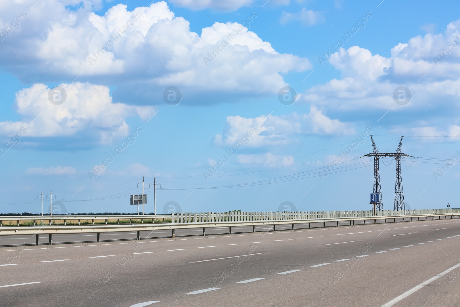 Photo of View of asphalt highway under blue sky