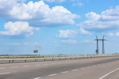 View of asphalt highway under blue sky