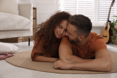 Lovely couple enjoying each other on floor in living room