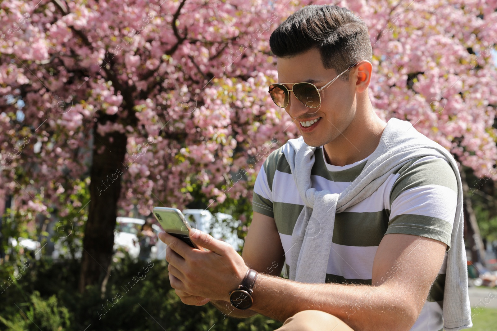 Photo of Happy handsome man taking selfie in park