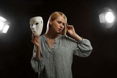 Photo of Professional actress rehearsing with mask on stage in theatre