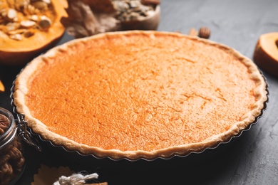 Photo of Delicious homemade pumpkin pie on black table