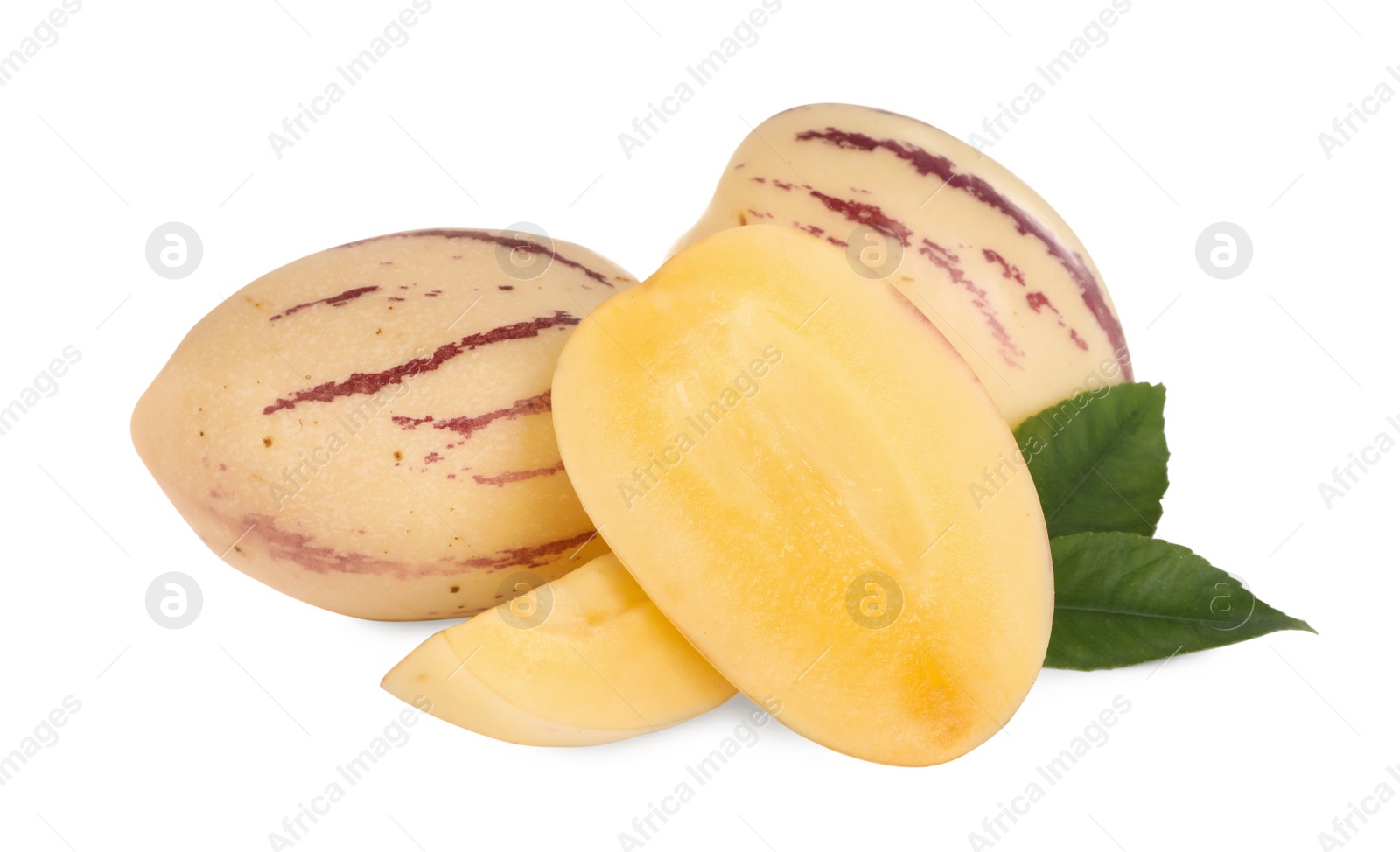 Photo of Whole and cut pepino melons with green leaves isolated on white