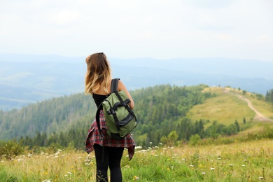 Photo of Woman with backpack in wilderness on cloudy day