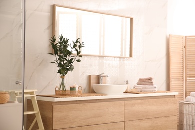Photo of Modern bathroom interior with stylish mirror and vessel sink
