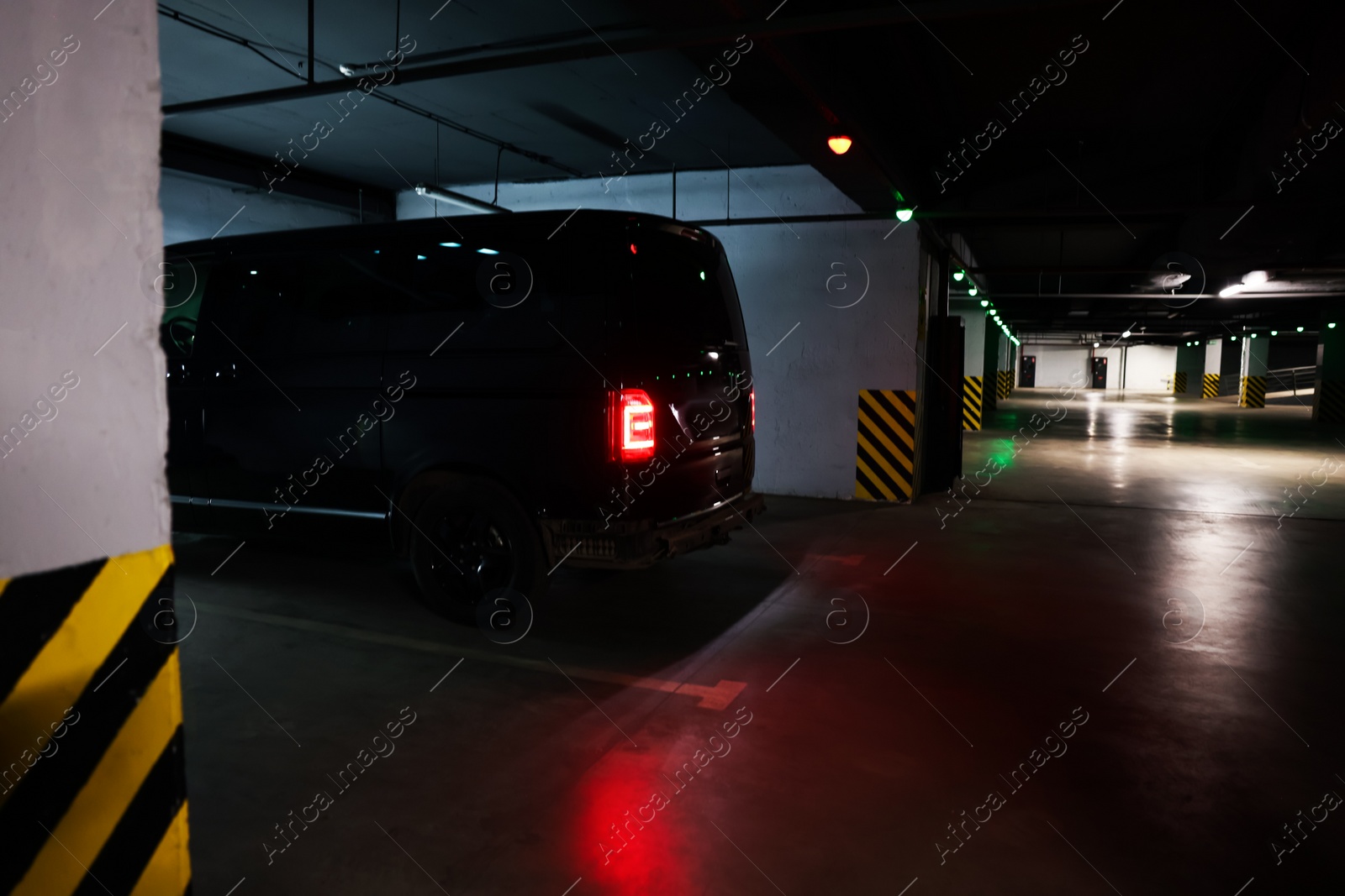 Photo of Black van in parking garage at night