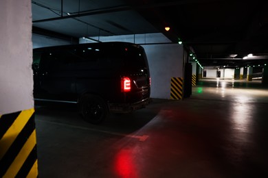 Photo of Black van in parking garage at night