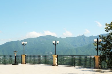 Beautiful mountains from viewpoint with fence and lamps