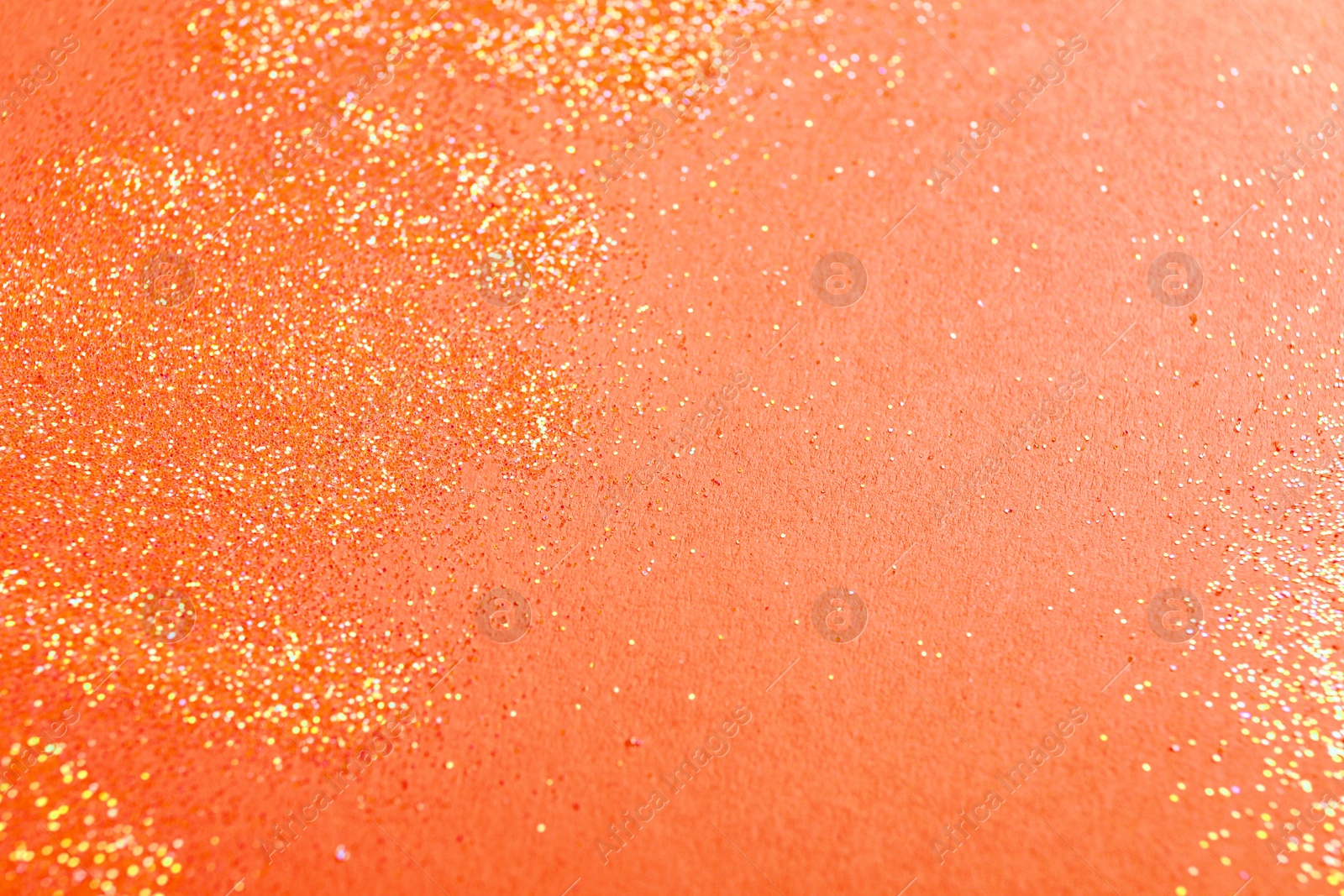Photo of Shiny bright glitter on pink background, space for text
