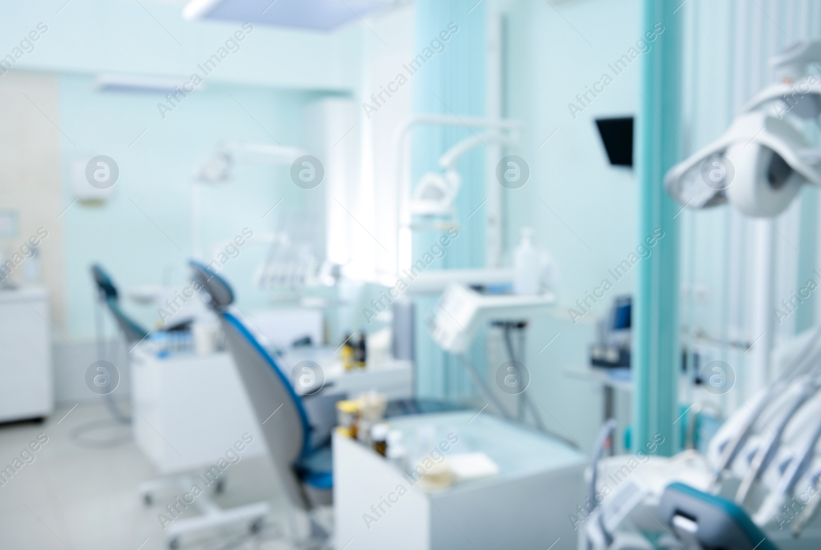 Photo of Blurred view of dentist office with chairs and professional equipment