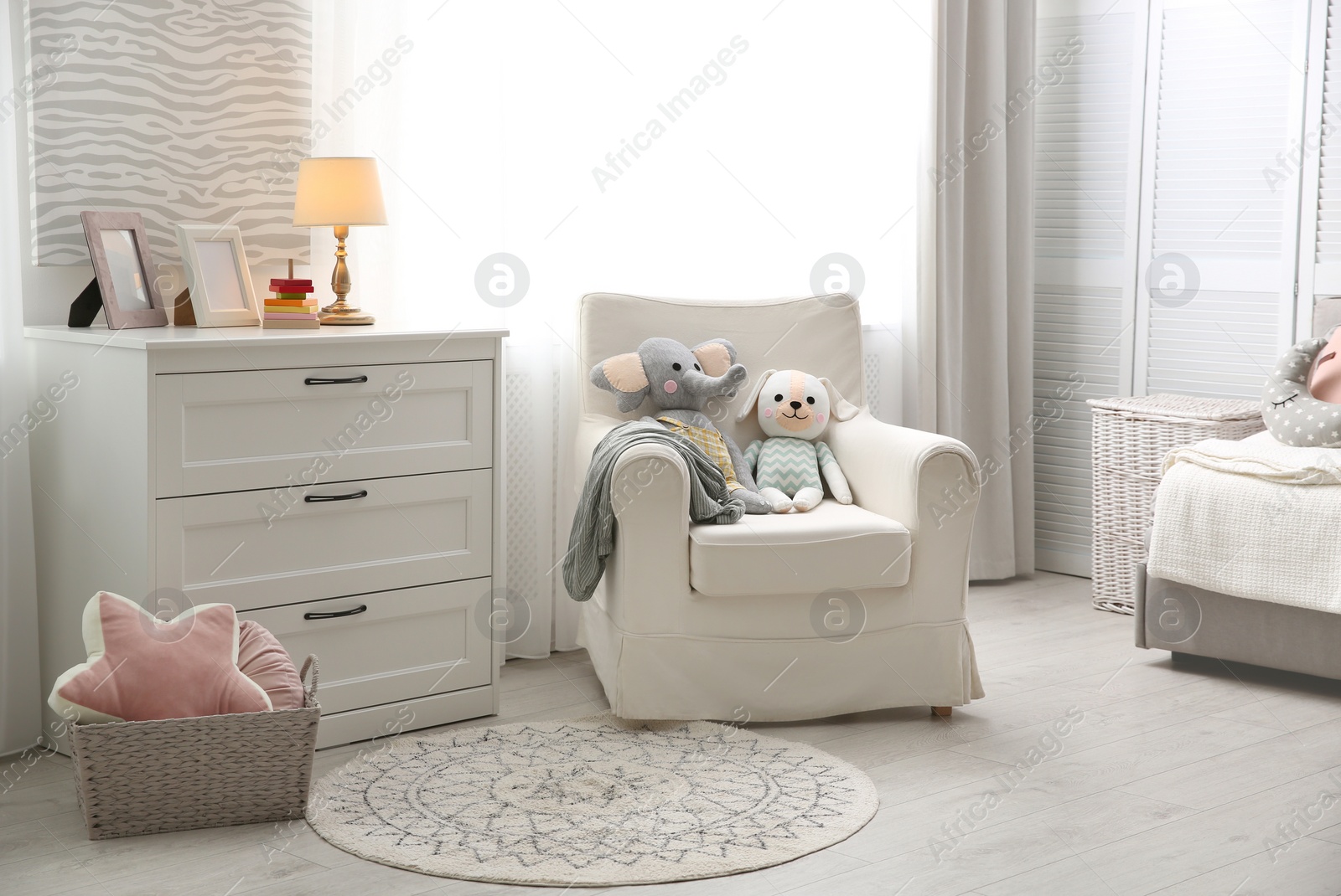 Photo of Comfortable armchair in modern baby room interior