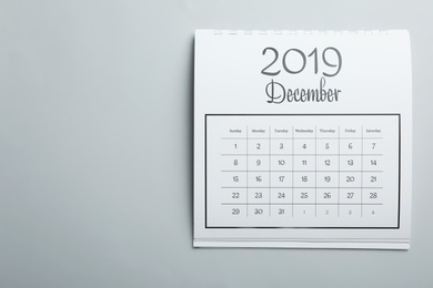 Photo of December 2019 calendar on light grey background, top view. Space for text