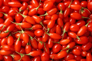 Photo of Fresh ripe goji berries as background, top view