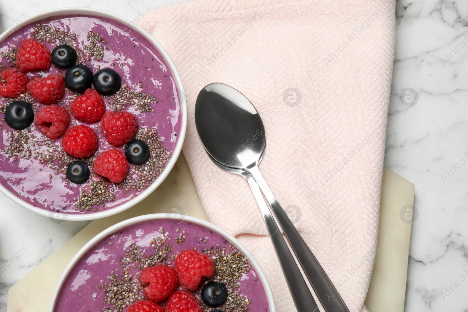 Photo of Delicious acai smoothie with fruits served on white marble table, flat lay