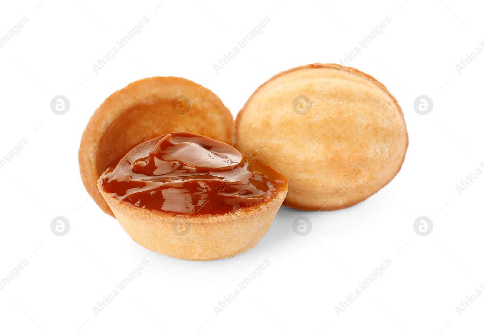 Photo of Delicious nut shaped cookies with boiled condensed milk on white background