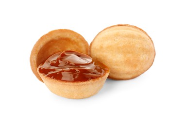 Photo of Delicious nut shaped cookies with boiled condensed milk on white background