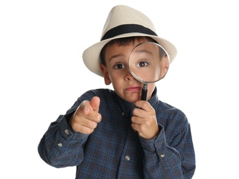 Little boy with magnifying glass playing detective on white background