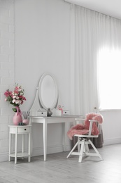 Stylish room interior with white dressing table