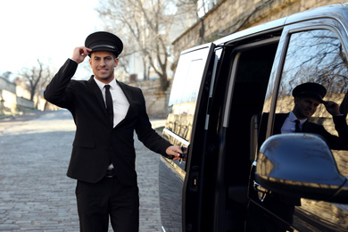 Driver opening door of luxury car. Chauffeur service