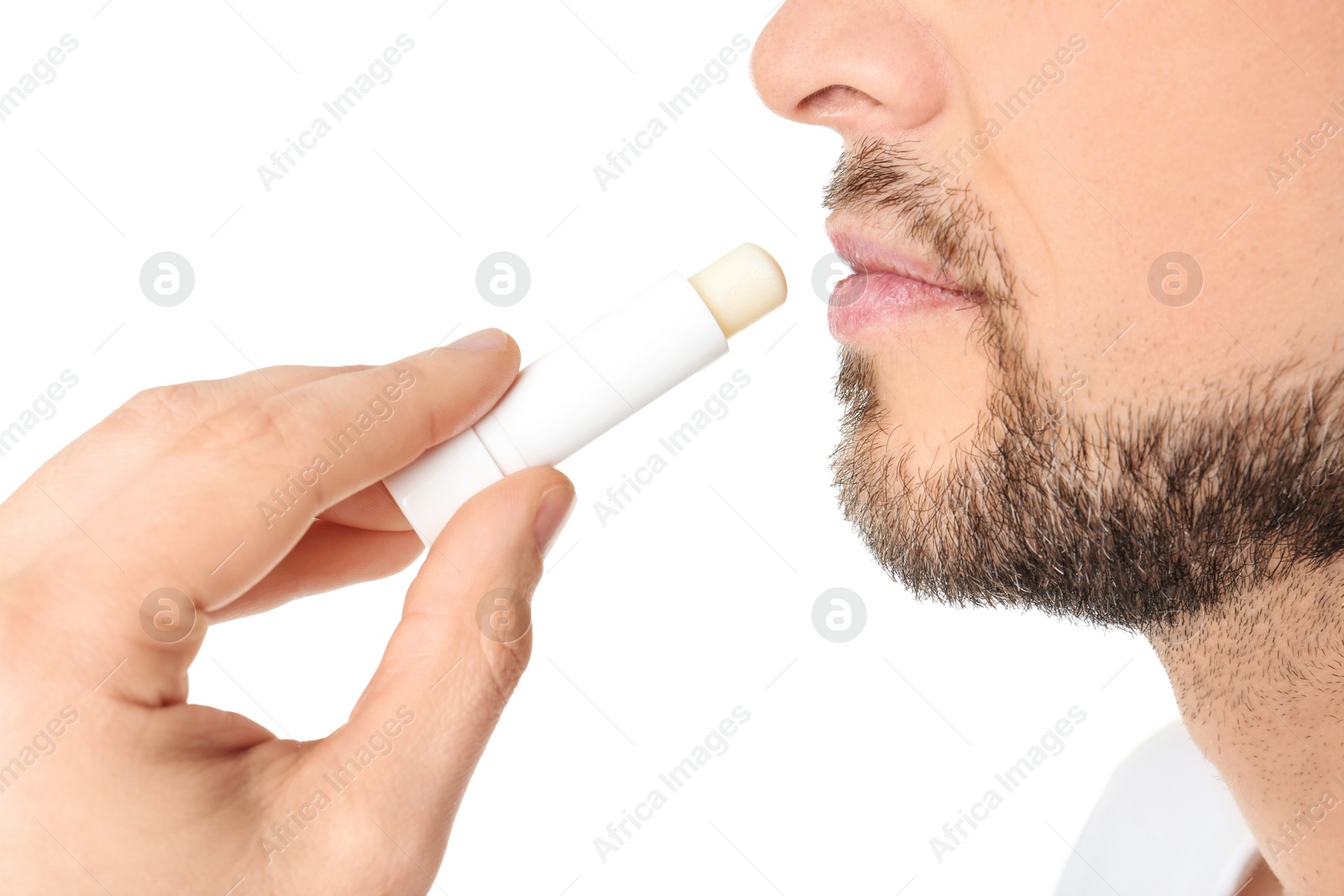 Photo of Man applying hygienic lip balm, on white background