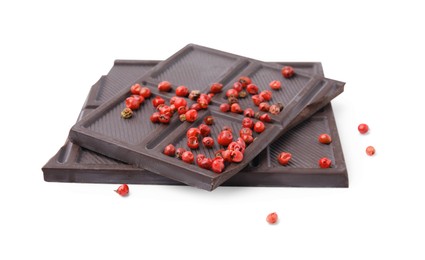 Dark chocolate pieces with red peppercorns isolated on white