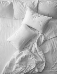 Photo of Soft pillows on comfortable bed, top view