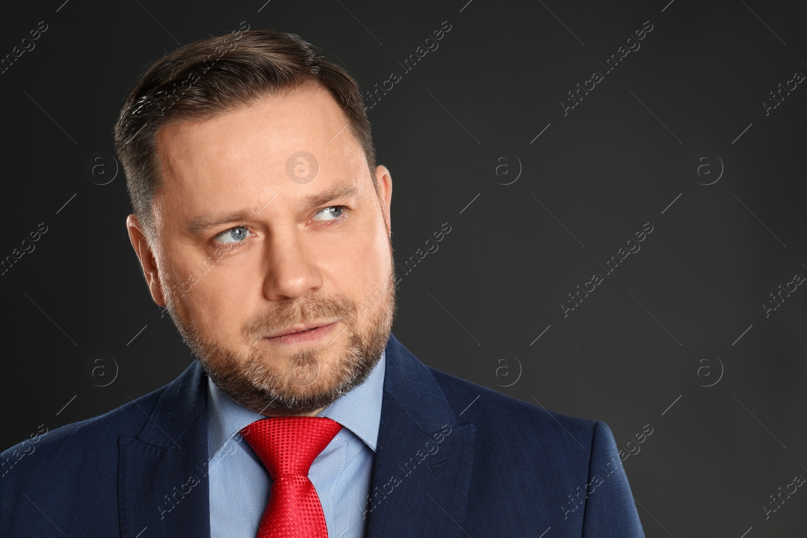 Photo of Portrait of mature man on black background