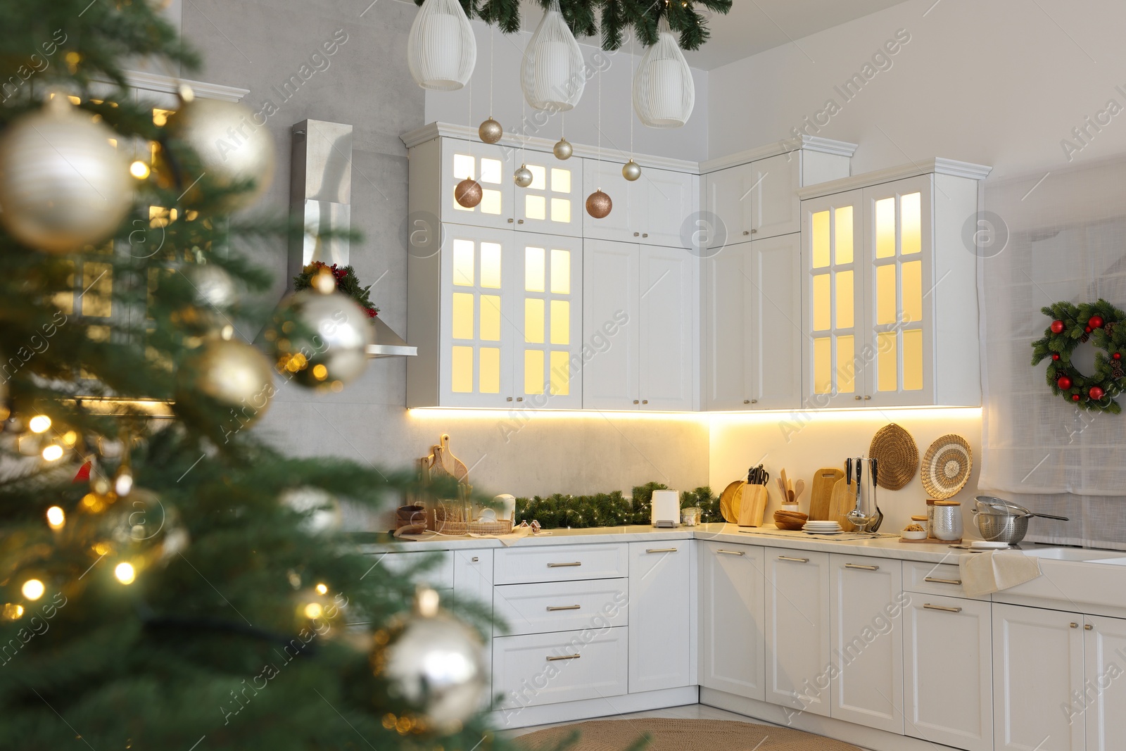 Photo of Cozy spacious kitchen decorated for Christmas. Interior design