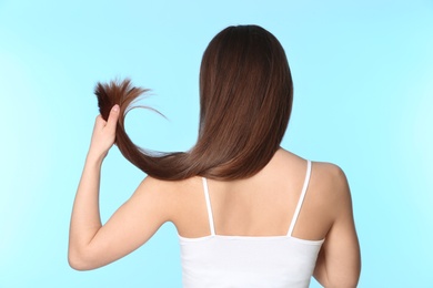 Photo of Woman with long brown hair on color background