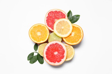 Photo of Different cut citrus fruits and leaves on white table, flat lay