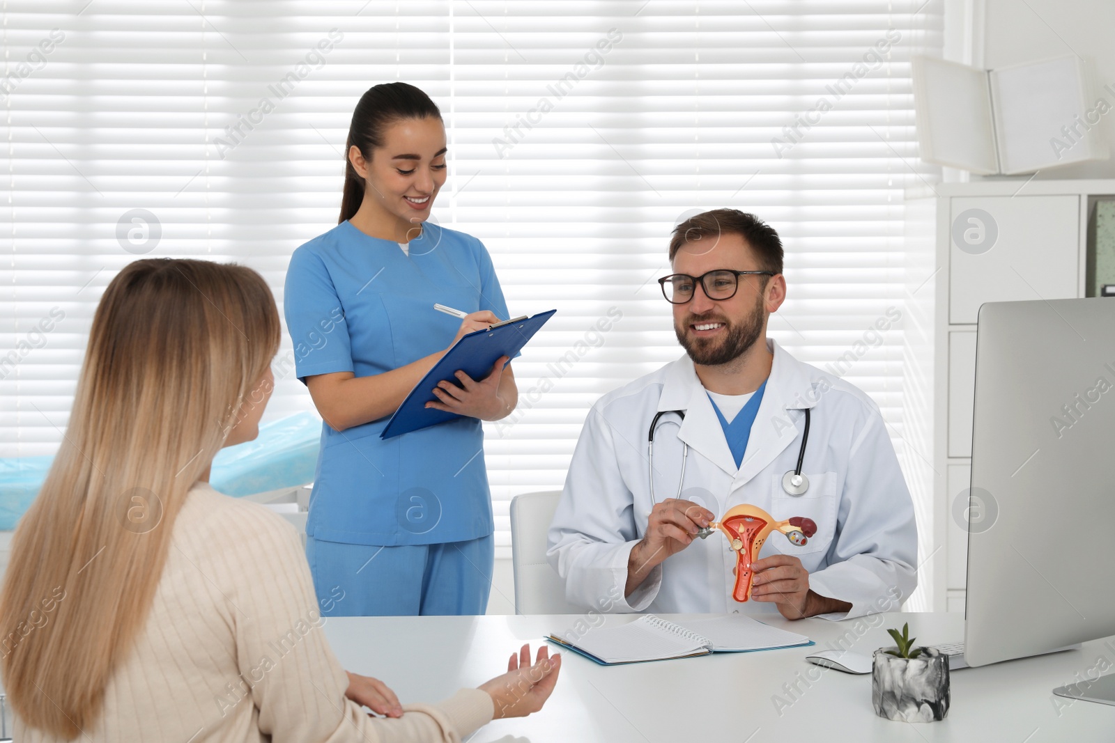 Photo of Young woman having appointment with gynecologist in clinic