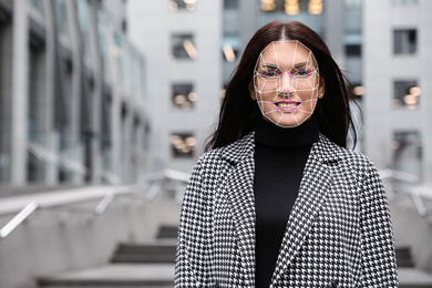 Image of Facial recognition system. Mature woman with digital biometric grid, outdoors
