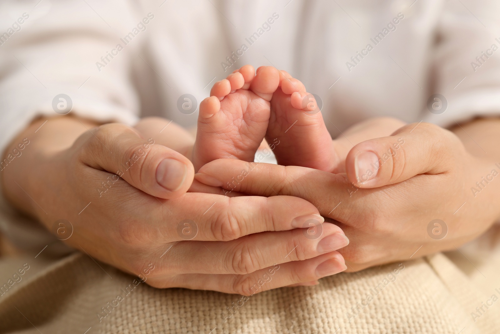 Photo of Mother holding her newborn baby, closeup view