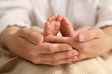 Photo of Mother holding her newborn baby, closeup view