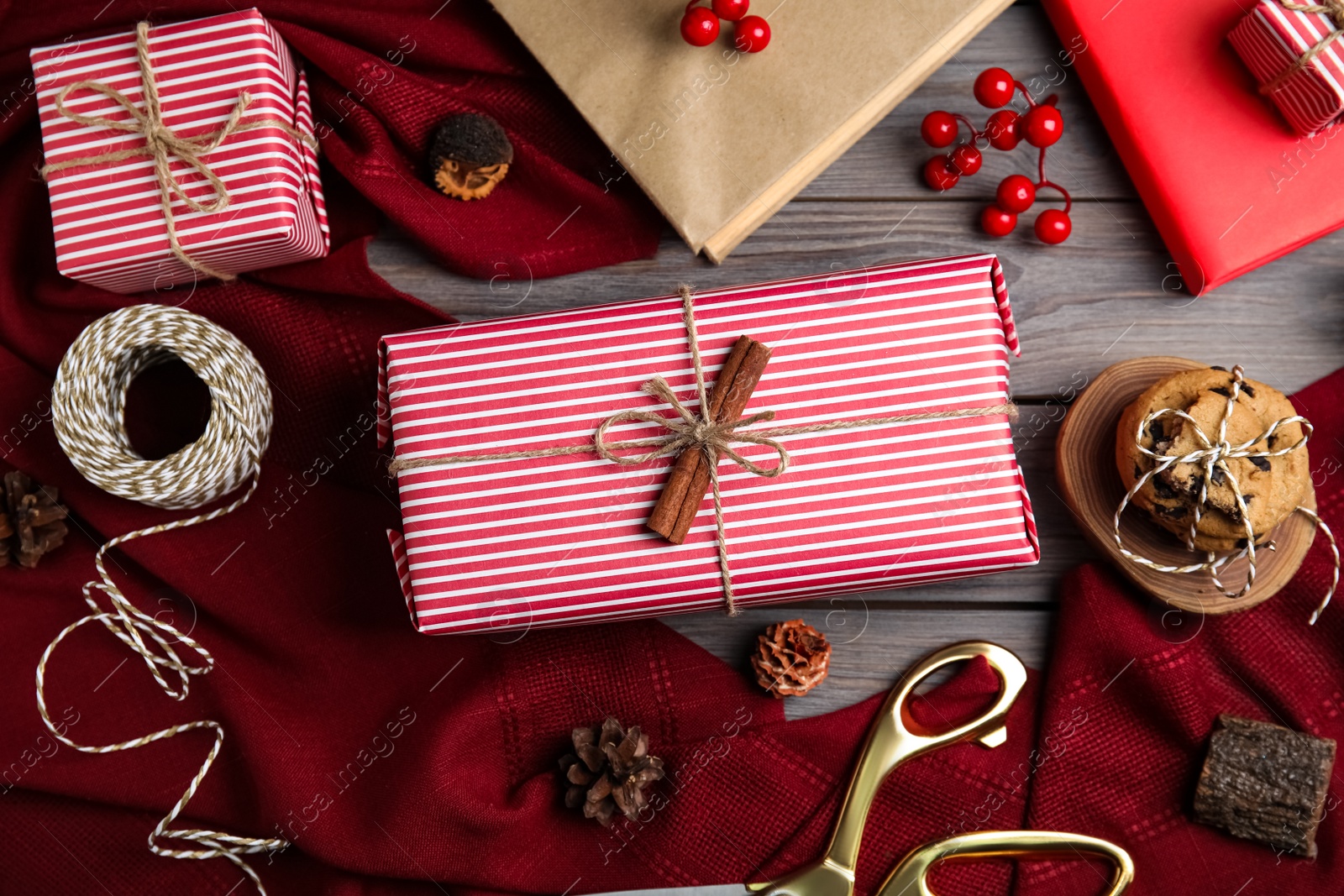 Photo of Flat lay composition with beautifully wrapped gift boxes on wooden table