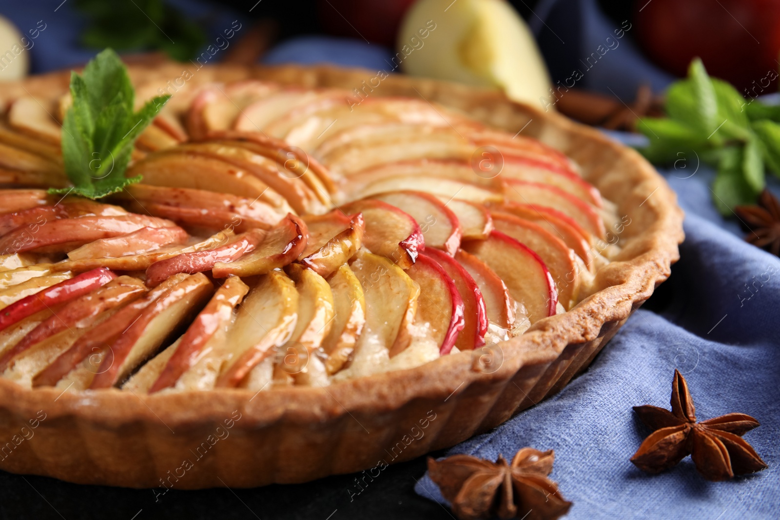 Photo of Delicious homemade apple tart with mint on table, closeup