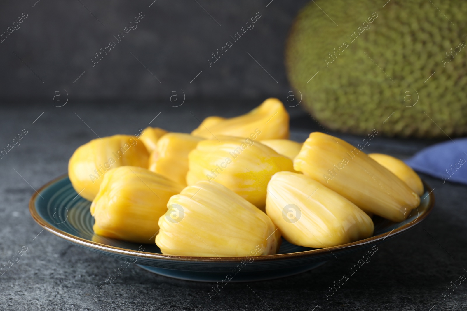 Photo of Fresh exotic jackfruit bulbs on grey table