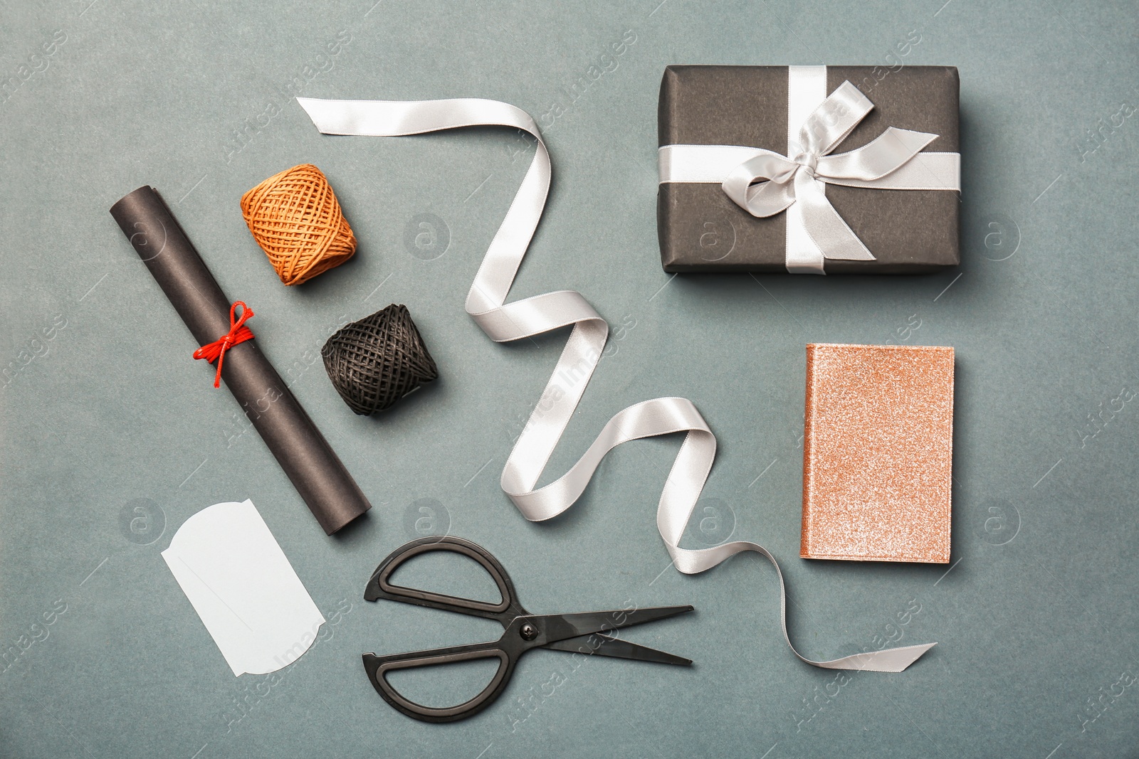 Photo of Composition with beautiful gift box and ribbon on color background, top view