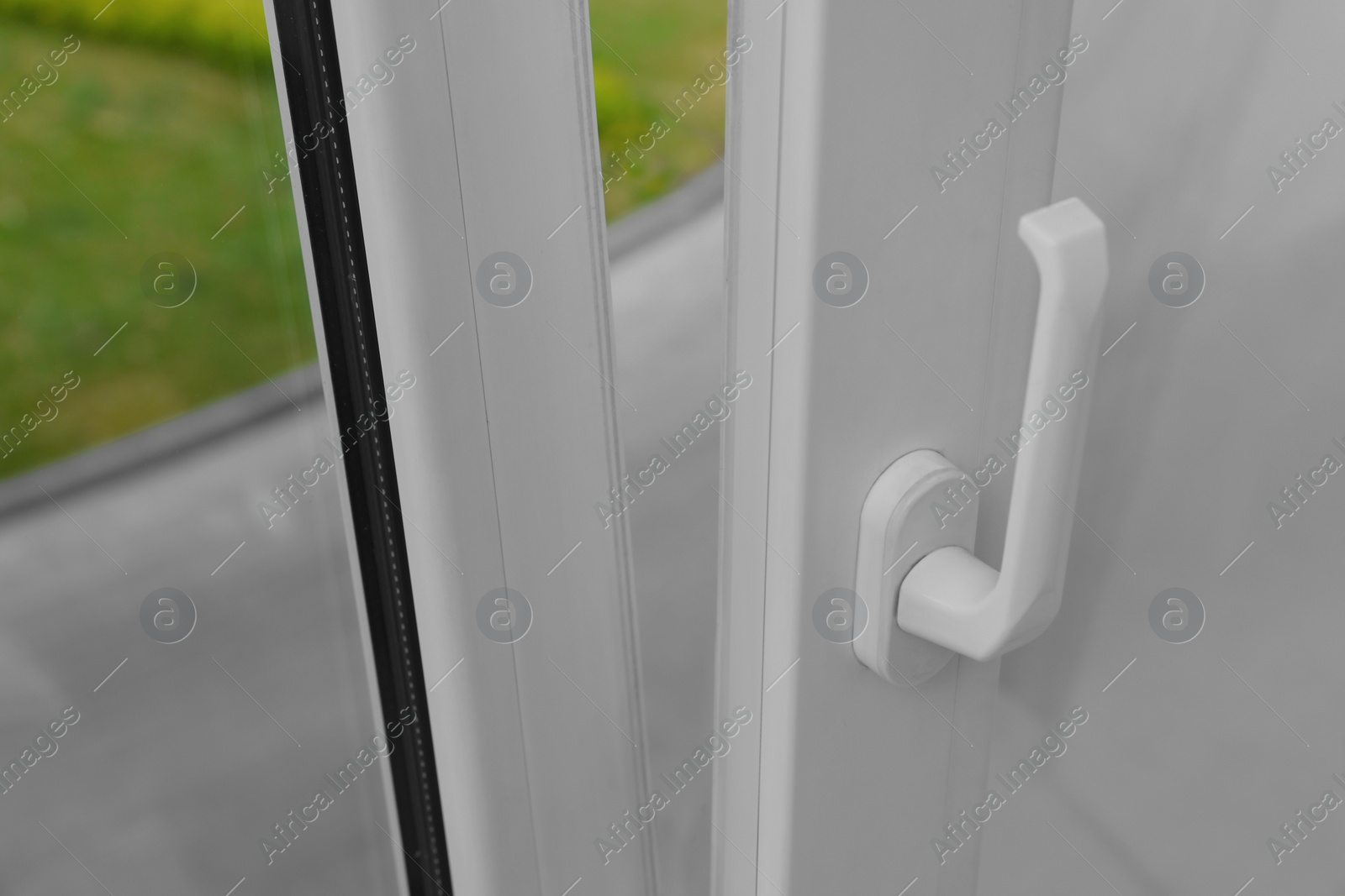 Photo of Open window with white plastic frame indoors, closeup