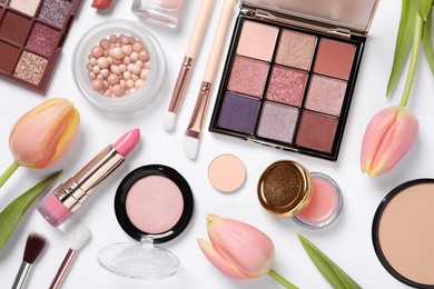 Photo of Flat lay composition with eyeshadow palette and beautiful tulips on white background