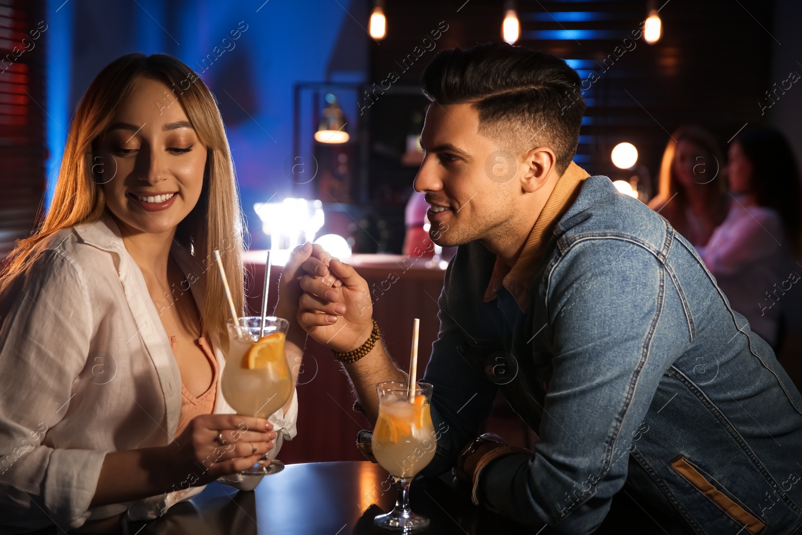 Photo of Man and woman flirting with each other in bar