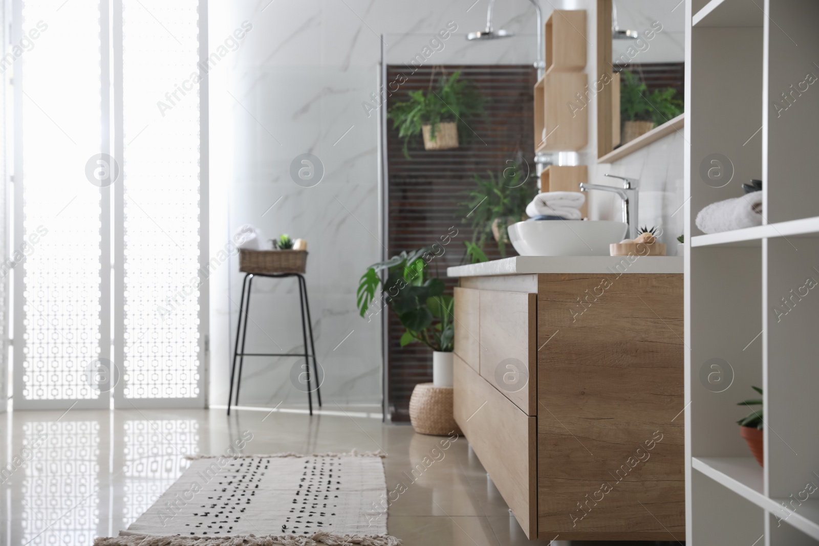 Photo of Bathroom interior with shower stall, counter and houseplants. Idea for design