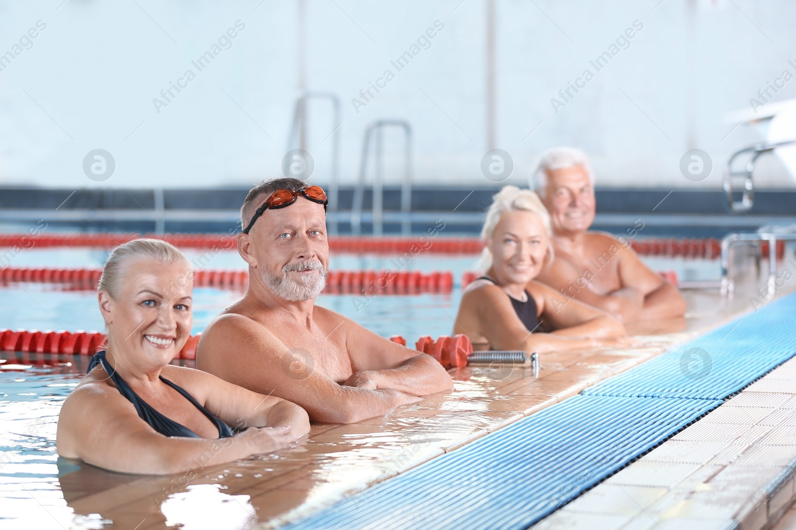 Photo of Sportive senior people in indoor swimming pool