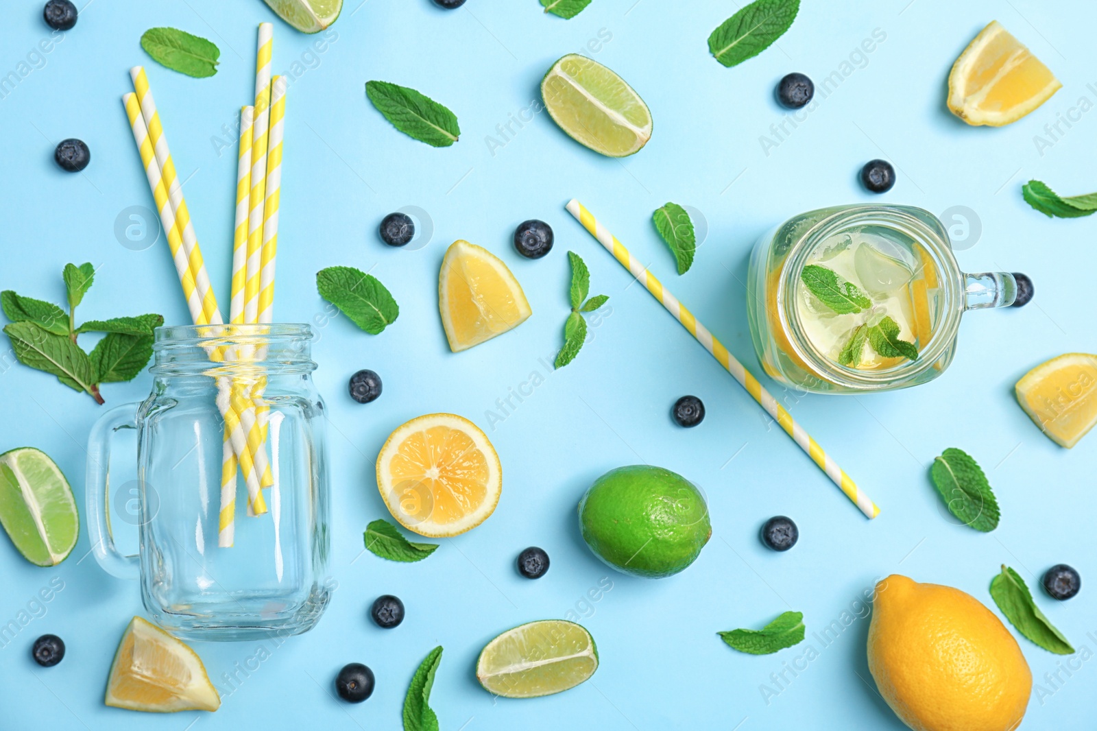 Photo of Flat lay composition with delicious natural lemonade on color background