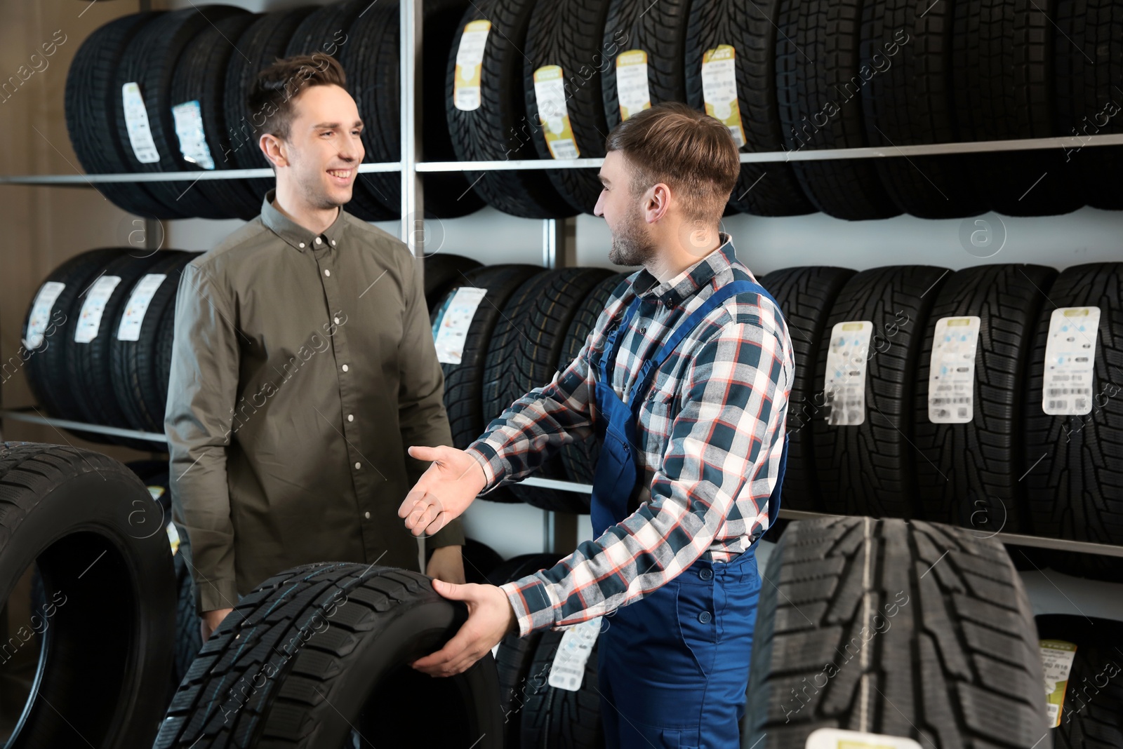 Photo of Service center consultant helping customer to choose tire in store